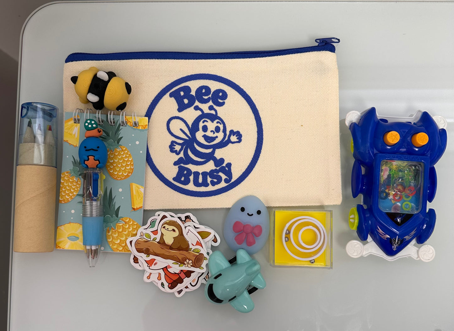 Bee Busy Bags including bag,writing pad, fun pen, colored pencil pack, stickers plus at least 4 sensory toys - plus a Bee fidget toy. Available in girls, boys and gender neutral collections. Age 2-6