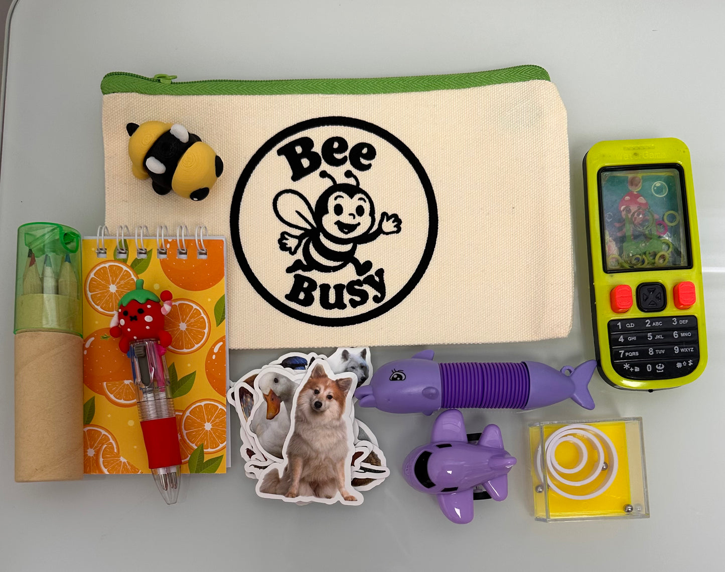Bee Busy Bags including bag,writing pad, fun pen, colored pencil pack, stickers plus at least 4 sensory toys - plus a Bee fidget toy. Available in girls, boys and gender neutral collections. Age 2-6